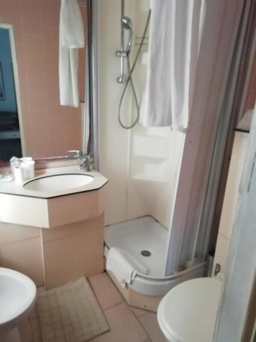 a bathroom with a sink and a shower and a toilet at HOTEL GIORDANA in Loano