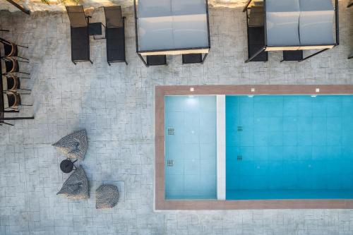 an overhead view of a swimming pool in a building at Suites Olive Tree Farm Episkopi Village in Episkopí- Rethimno