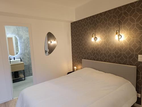 a bedroom with a white bed and a sink at JEAN JAURES in Dijon