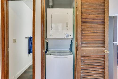 a washer and dryer in a room with a door at Vernon Township Condo with Balcony Near Ski Lifts! in Vernon Township
