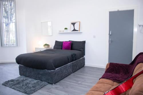 a bedroom with a bed and a couch in it at Central Blissful Haven in Liverpool