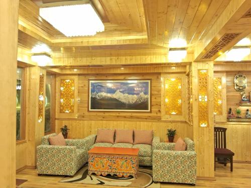 a living room with a couch and a painting on the wall at Hotel Zingkham Residency in Gangtok