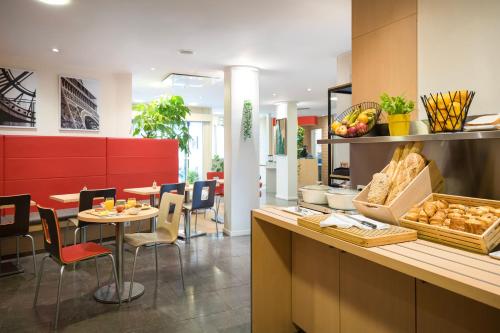 a restaurant with a counter with a table and chairs at ibis Paris Gare de Lyon Reuilly in Paris