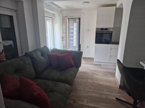 a living room with a couch and a kitchen at small apartment for two in Brus