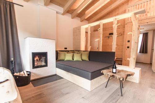 a living room with a bed and a fireplace at Chalet Berg in Selva dei Molini