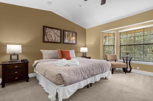 a bedroom with a bed with two towels on it at 8543 - 4BR Disney World Vacation Townhome in Orlando