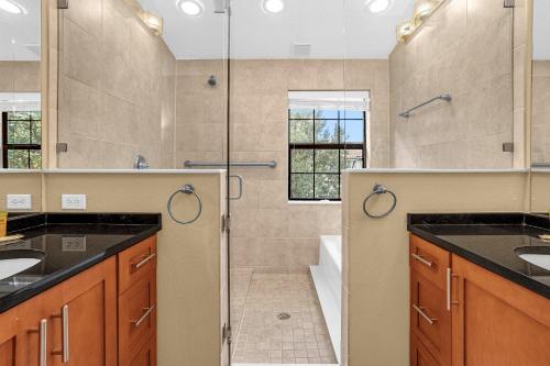 a bathroom with two sinks and a shower at 8543 - 4BR Disney World Vacation Townhome in Orlando