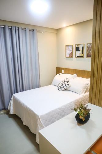 two beds in a room with white sheets at APARTAMENTO FLAT STUDIO WEST FIT 711 a in Mossoró