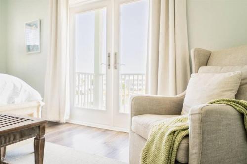 a living room with a couch and a window at Green Family Bungalow! Beach Access, Pool, & Fishing Dock in Gulf Shores