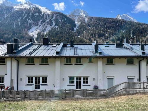 a large white house with mountains in the background at Haus Peppone in Mathon