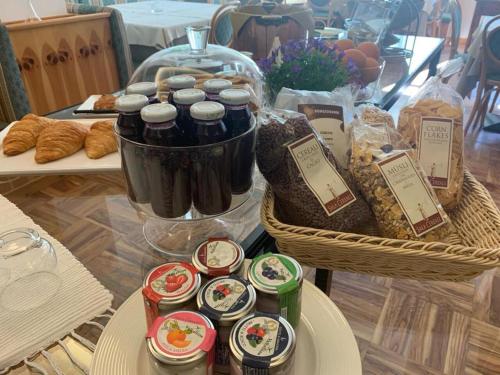 a table topped with baskets of food and bread at Hotel Posta in Aprica