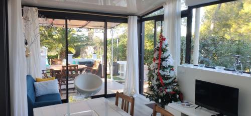 a living room with a christmas tree in the window at D'art d'art à Sanary in Sanary-sur-Mer