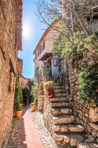 a stone alley with stairs in a stone building at Appartement neuf coup de coeur entre Èze et Monaco in Èze