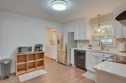 a kitchen with white cabinets and stainless steel appliances at North Charleston Escape about 15 Mi to Dtwn Charleston in Charleston