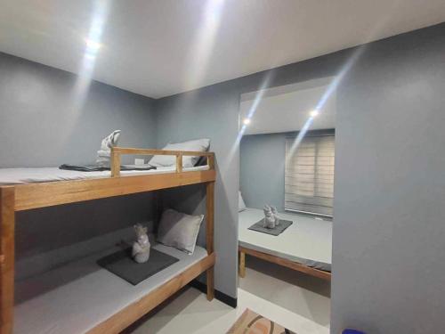two bunk beds in a room with lights on the ceiling at Mantilla Hostel in Coron