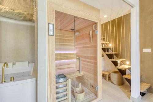 a bathroom with a shower and a sink at Luxury Suite - Jacuzzi et Sauna in Arpajon