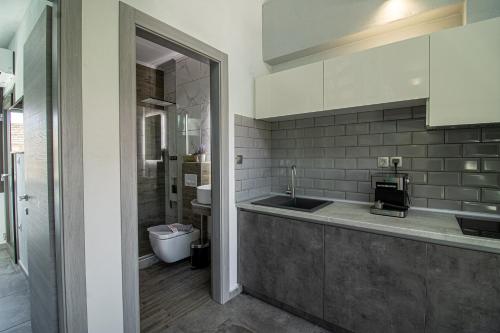 a kitchen with a sink and a toilet at STREET 90 Lux Aparts in Keramoti