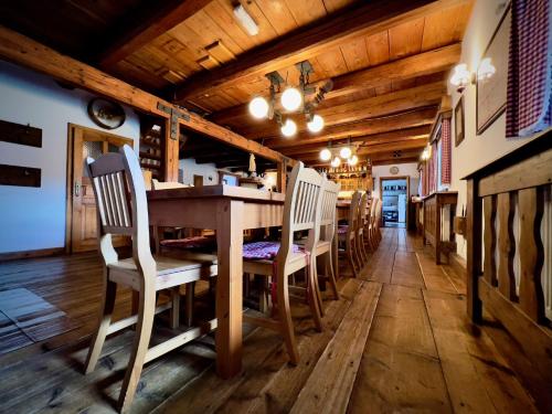 a dining room with a long wooden table and chairs at Penzion Stanský Mlýn in Hlinsko