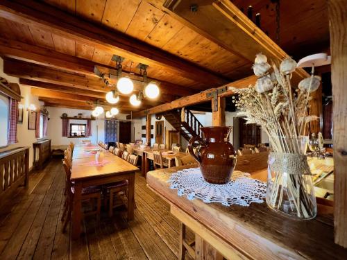 a dining room with wooden tables and chairs at Penzion Stanský Mlýn in Hlinsko