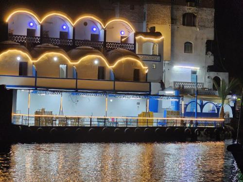 a building next to a river at night at Endo Mando in Shellal