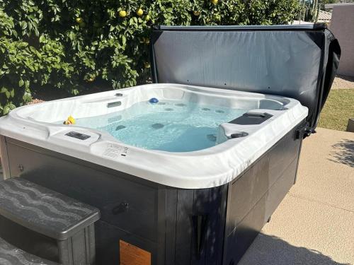 a jacuzzi bath tub sitting on a patio at Private Tuscany Oasis with Pool - Perfect for families, couples or business travelers home in Phoenix