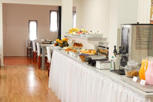 a buffet line with food on top of it at Pousada Paraíso in Cambará