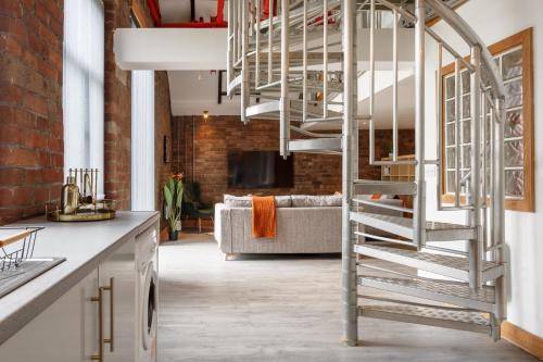 a spiral staircase in a kitchen with a living room at Broadgate Penthouse Apartment in Bradford