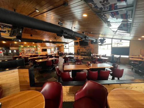 a restaurant with wooden floors and tables and chairs at The Patch Lodge in Warroad