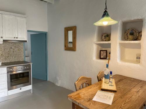 a kitchen with a wooden table and a dining room at Folegandros-Cliffhouse in Chora Folegandros