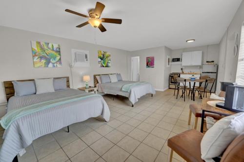 a bedroom with two beds and a living room at Sea Foam Suites in Panama City Beach