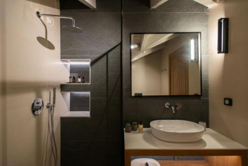 a bathroom with a sink and a mirror at YOLO Resort - Loft in Alykes