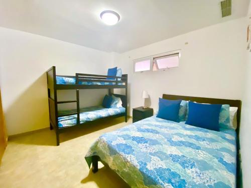 a bedroom with a bed and a bunk bed at 703 Marbella 2 bedrooms Beachfront Beautiful Apartment in San Pedro de Macorís