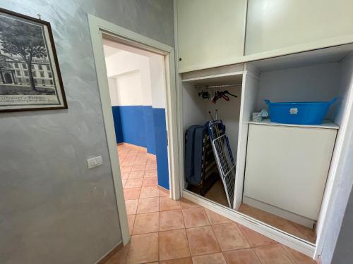 a walk in closet with a white door and a hallway at Villa Lidia & Attico degli artisti, free pets , giardino recintato e attrezzato in Minturno