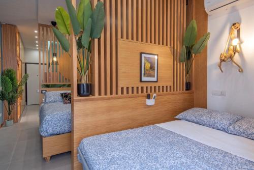 a bedroom with two beds and plants on the wall at Napoli Suite Station in Naples