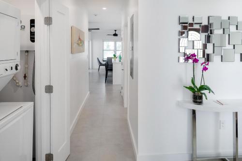 a hallway of a home with white walls and white floors at Carpe Diem 3 BR Condo in The Bight Settlements