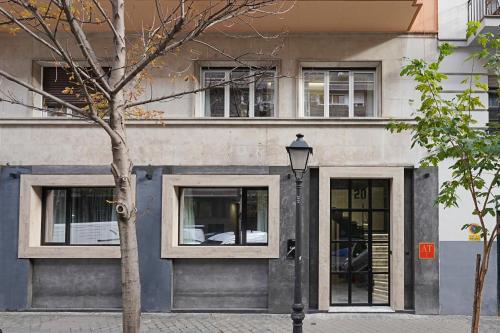 a building with three windows and a street light at numa I Goya Apartments in Madrid