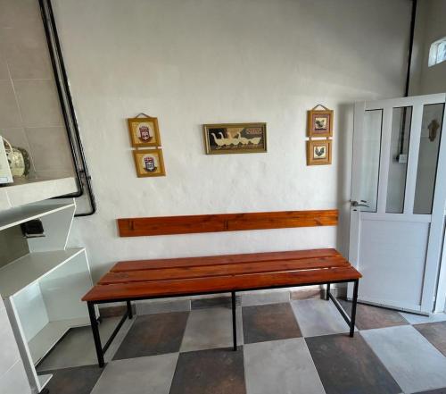 a wooden bench sitting on a wall in a room at Babu Apart in Mar del Plata