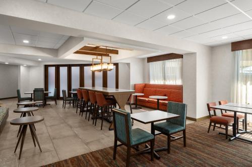 a dining room with tables and chairs and windows at Hampton Inn Carefree, Az in Carefree