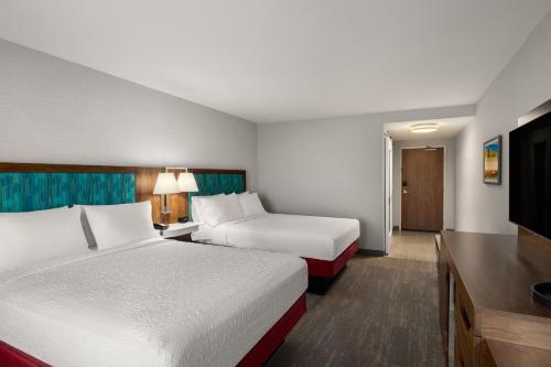 a hotel room with two beds and a flat screen tv at Hampton Inn Carefree, Az in Carefree