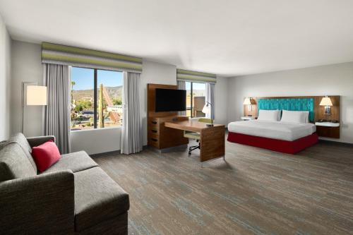 a hotel room with a bed and a desk and a couch at Hampton Inn Carefree, Az in Carefree