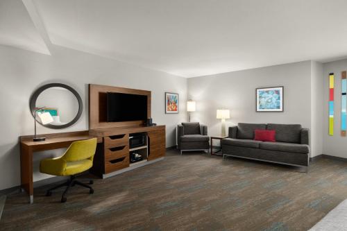 a living room with a television and a couch and a chair at Hampton Inn Carefree, Az in Carefree
