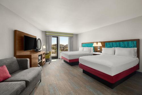 a hotel room with two beds and a couch at Hampton Inn Carefree, Az in Carefree