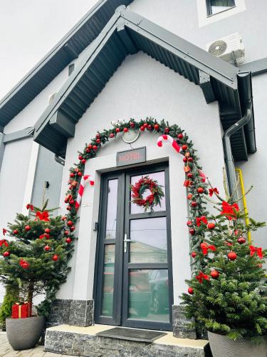 a christmas front door with christmas trees and areath at Grey Boutique Hotel Palas in Iaşi
