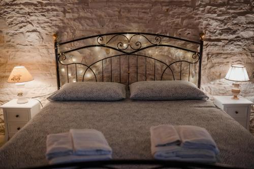 a bedroom with a bed with two towels on it at DOMUS Casa Vacanze in Terlizzi