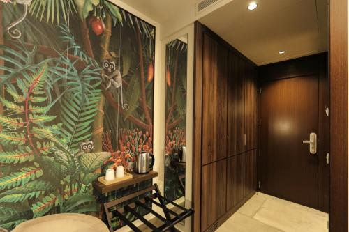 a hallway with a large mural of a plant at Ciutat de Girona in Girona