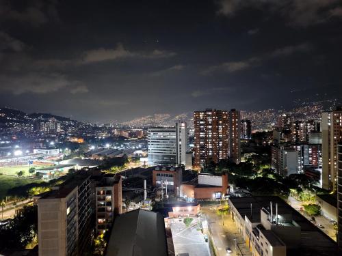 a view of a city at night at Modern High-Rise 2/2 Apartment with City View. in Sabaneta