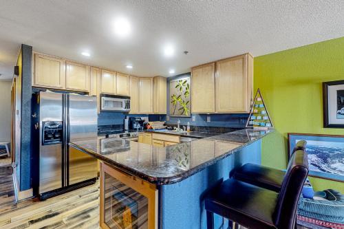 a kitchen with wooden cabinets and a counter top at La Rive Del Lago 302 in Dillon
