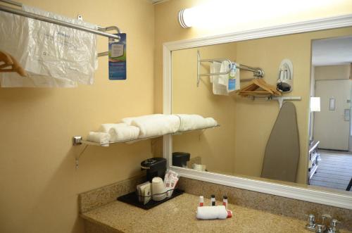 a bathroom with a sink and a mirror at Baymont by Wyndham Lynchburg in Lynchburg