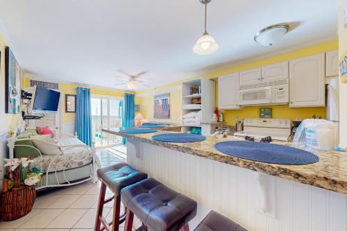 a kitchen with two sinks and a bed in a room at Makai 404 in Ocean City