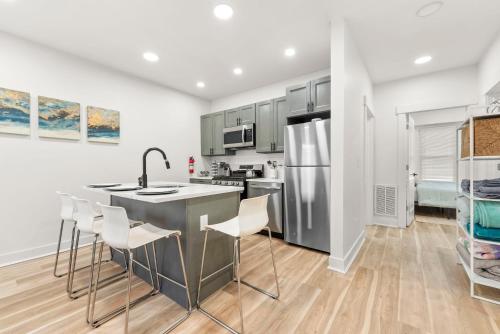 a kitchen with stainless steel appliances and wooden floors at 10Guests! Parking 1ST FLOOR-Duplex in Fair Lawn